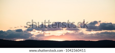 Beautiful sky at sunset over dark mountains