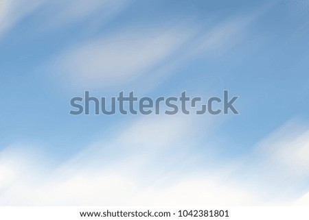 defocused blue background, sky white clouds in motion