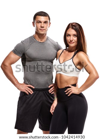 Athletic young couple in sportswear posing after training Royalty-Free Stock Photo #1042414930