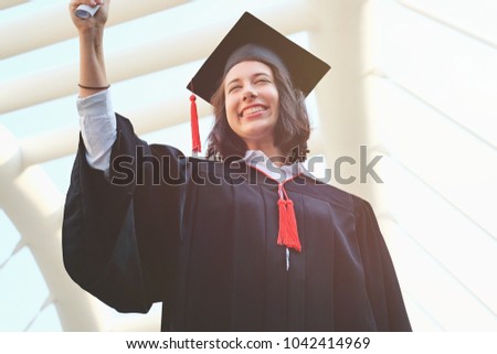 Successful student on graduation day, man student in graduation cap with certificate, smiling asian student showing  certificate