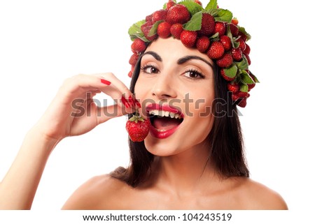 Fun woman with strawberry hat eating struwberry