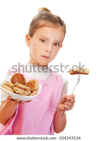 Beautiful little girl holding plate of meatballs, isolated on white background.