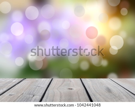 Selective focus image of empty wood floor with blurred grass of nature park background and summer season - image for used display or montage your products.