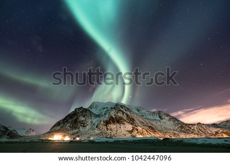 Northen light under mountains. Beautiful natural landscape in the Norway Royalty-Free Stock Photo #1042447096