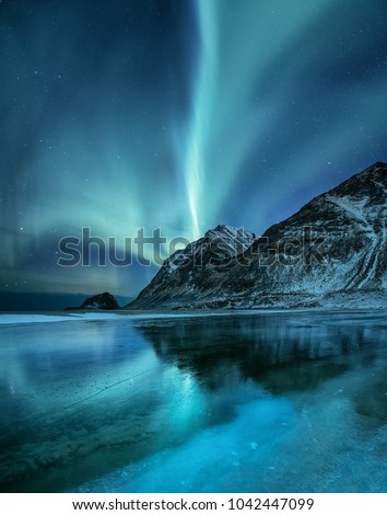 Northen light under mountains. Beautiful natural landscape in the Norway Royalty-Free Stock Photo #1042447099