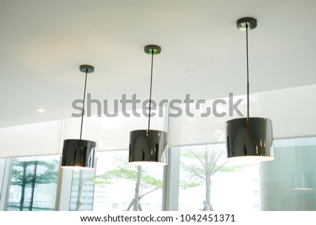Fashion Light lamp hanging from the white ceiling decorate in the office use as interior design.