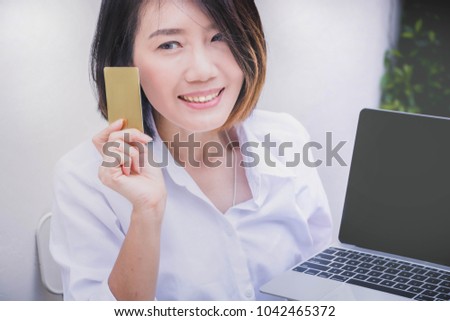 Asian business woman holding credit card payment with laoptop online shopping online concepts. Markting business women working with  computer technolohy device.