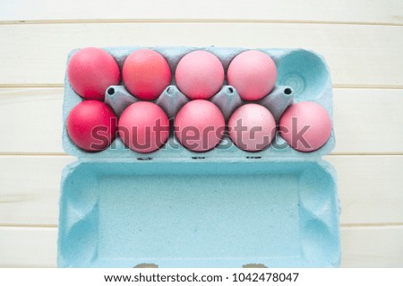 Pink easter eggs.Easter.Pastel shades.Shades of pink.Pink background.Wooden background.Natural chicken eggs.The tray for eggs.