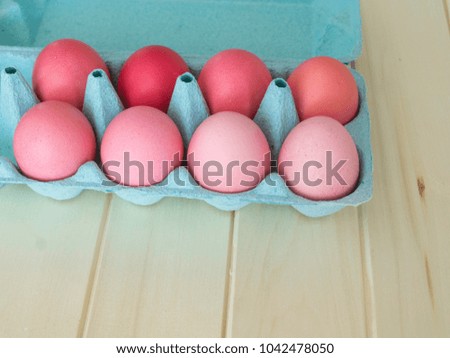 Pink easter eggs.Easter.Pastel shades.Shades of pink.Pink background.Wooden background.Natural chicken eggs.The tray for eggs.