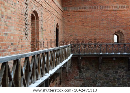 this picture shows a wooden balcony in the old castle on the island of Trakai.