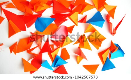 red, orange and blue paper clippings, colourful background.