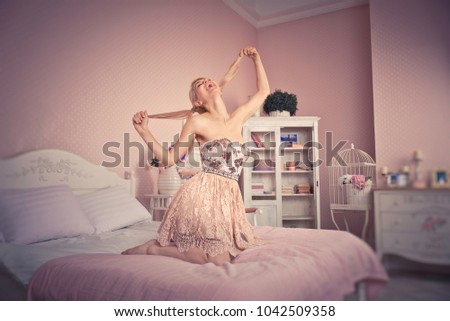 Blonde doll girl in a toy house