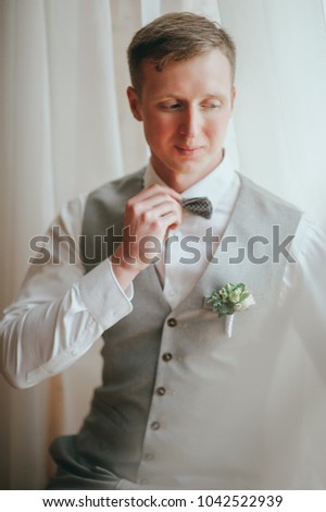 Handsome groom at wedding tuxedo waiting for bride. Rich groom at wedding day