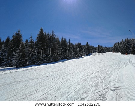 Empty ski run on a beautiful sunny day. Clear sky. Different angles