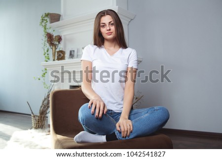 Beautiful girl in white t-shirt with long and beautiful hair on dark background, emotion. Mock-Up