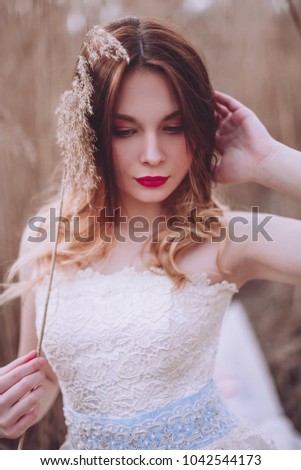 Beautiful romantic european girl with guitar with flowers inside, posing outdoors. Concept of music and nature. Spring time.