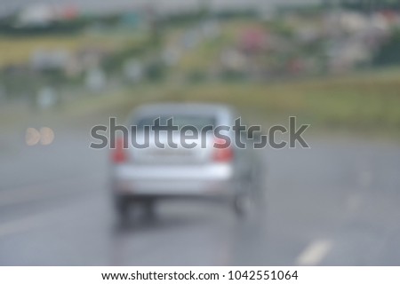 Blurred picture of the road, the car is driving on a rainy road
