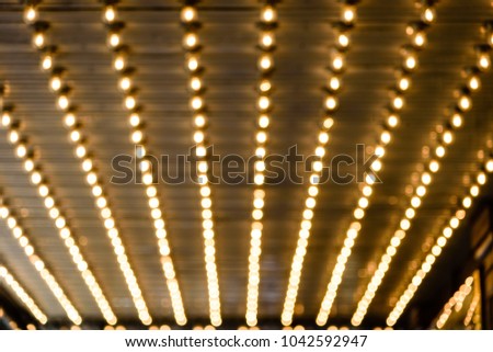 Rows of illuminated globes under the marquee, as often used at the entrance to theatres and casinos
