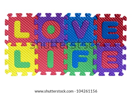 The words "Love Life" written with alphabet puzzle letters isolated on white background