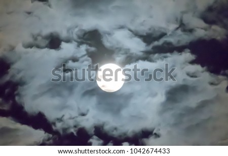 Full moon and white clouds sky background in the middle night, look bright and beautiful. 