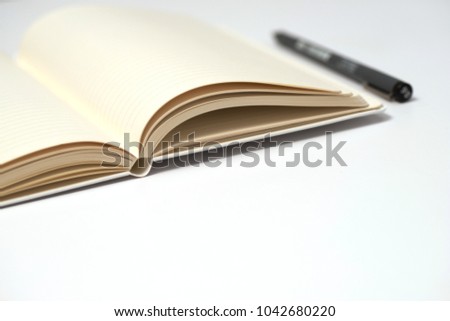 Notebook, pen and notepad on White background