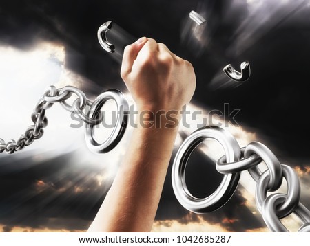 Fist smashes the fetters. Chains in the form of procent sign. Concept freedom from the chains of slavery. Royalty-Free Stock Photo #1042685287