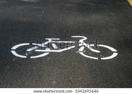 New black asphalt road for cyclists and runners, yellow stripes, markings. Summer sports background 