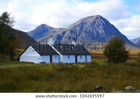 A white cottage near Glencoe on the West Highland Way in Scotland Royalty-Free Stock Photo #1042695997
