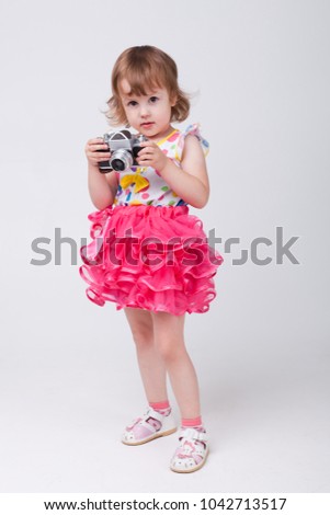 The girl is holding a camera