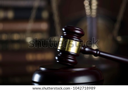 Law firm concept. Gavel, books, clock, balance, statue of justice.