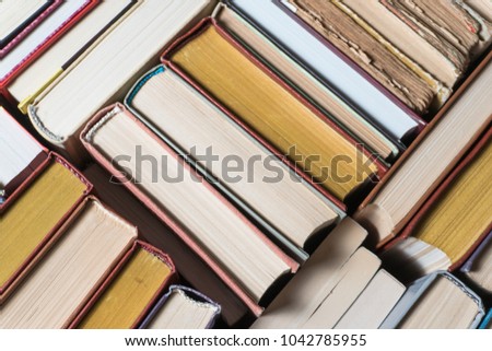 Many books in a bookstore or library on wooden background with copy space