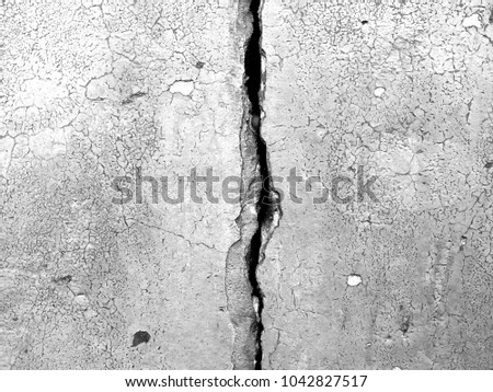 White black grey wall with cracks, texture background Royalty-Free Stock Photo #1042827517