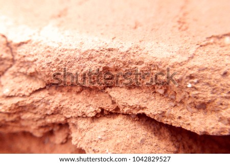 The texture of the brick red in the sun blurred background macro photo