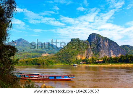 Tour boats in Mekong river, Luang Prabang, Laos Royalty-Free Stock Photo #1042859857