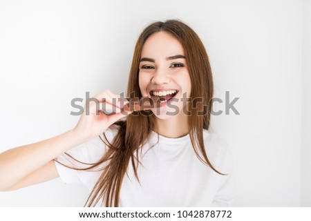 woman snacking on a bar of chocolate Royalty-Free Stock Photo #1042878772