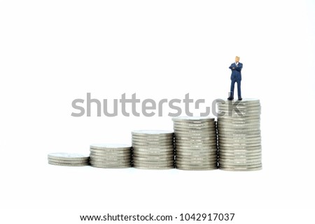 miniature figure people standding on a coin  with white blackground. Picture use for business concept