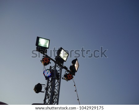 Three sport lights in outdoor concert and led lights with evening twightlight sky