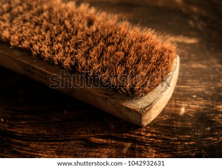 brown shoe polish and brush closeup photography