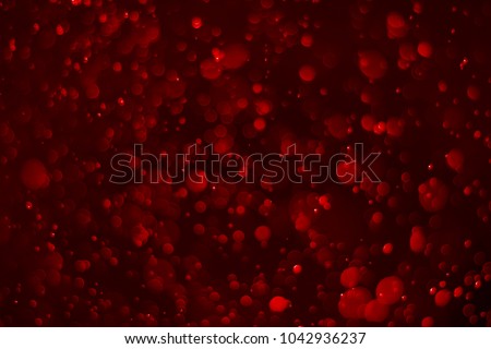 Abstract red bokeh background. Defocused background. Blurred bright light. Circular points.
