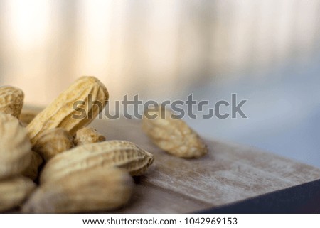 Close up Peanuts on wooden table. 