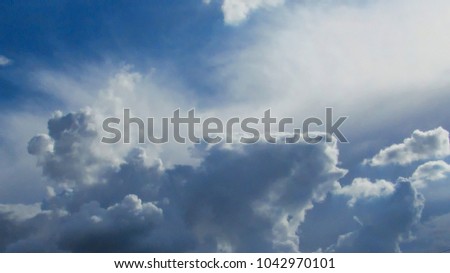 in the background Altostratus clouds and a piece of blue sky in the upper left of the picture and in the foreground cumulonimbus cloud illuminated laterally by the afternoon sun, sao paulo, brazil