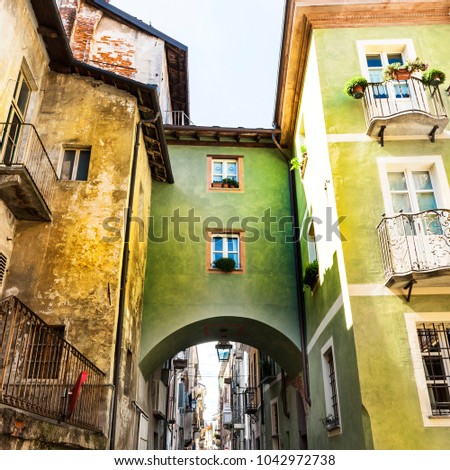Architecture of the Medieval Piedmont City of Cuneo in Italy. Vintage Italian lamps and balconies in Mediterranean style