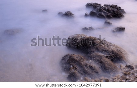 surreal seascpae rock and long exposure water soft smooth background with free copy space for text edit