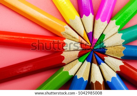 Colorful pencils in red background