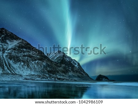 Northen light under mountains. Beautiful natural landscape in the Norway Royalty-Free Stock Photo #1042986109