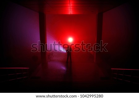 Creepy silhouette in the dark abandoned building. Horror about maniac concept or Dark corridor with cabinet doors and lights with silhouette of spooky horror person standing with different poses.