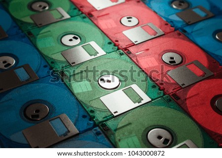 Colourful floppy disks arranged in a row close up. Vintage technology concept.