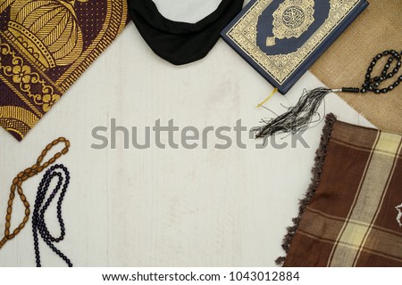 Ramadhan objects. Holy Quran, beautiful beads, prayer rugs, and moslem clothes. Royalty-Free Stock Photo #1043012884