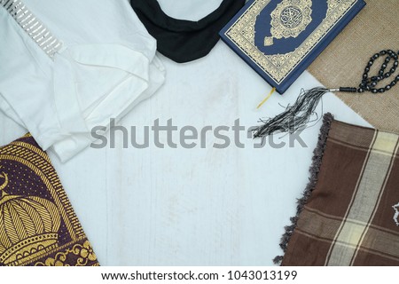 Ramadhan objects. Holy Quran, beautiful beads, prayer rugs, and moslem clothes. Royalty-Free Stock Photo #1043013199