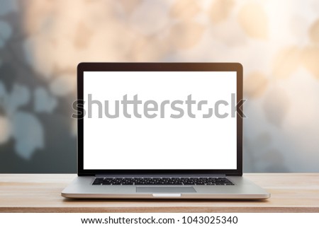 computer laptop with blank screen on wood table Royalty-Free Stock Photo #1043025340